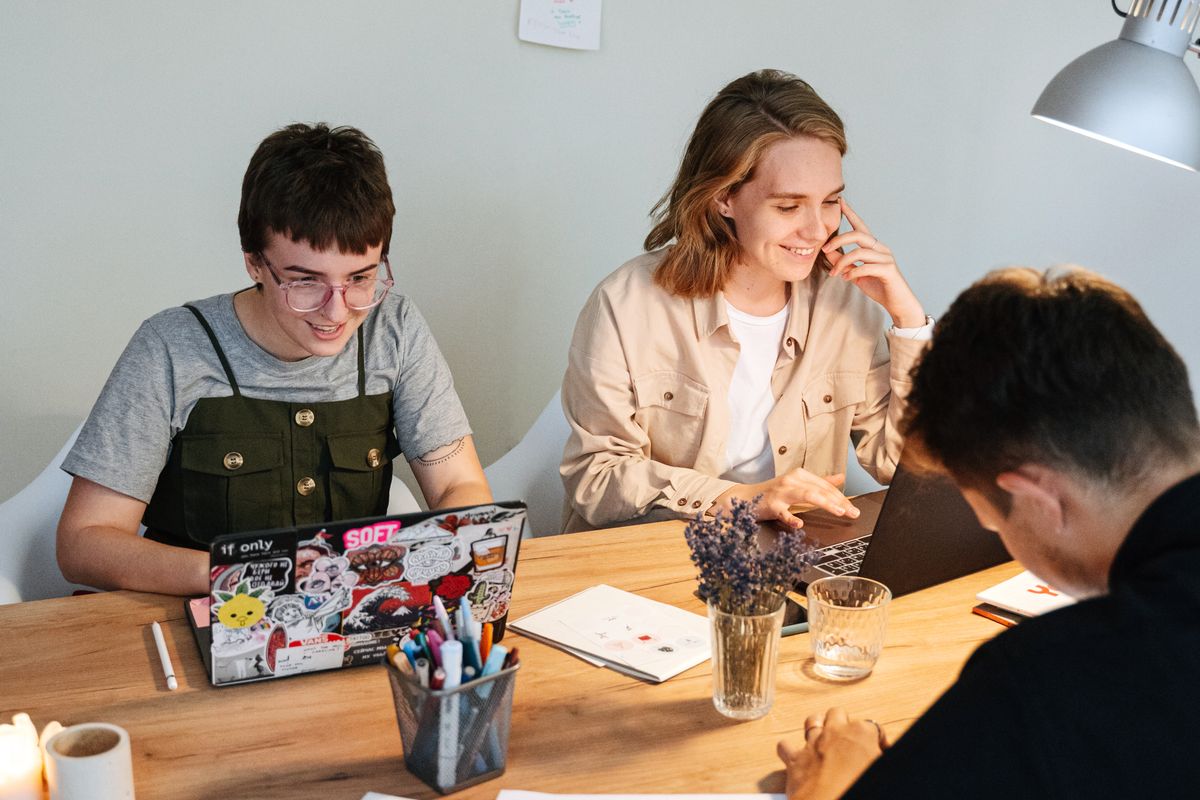 Two colleagues going through work on a laptop